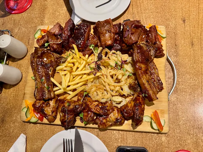 Ribs and wings sharing platter with fries and crispy onions